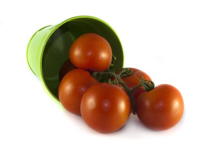 green container with red tomatoes on isolated white backgroundの写真素材