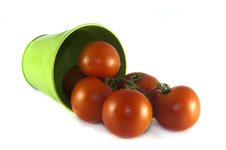 green container with red tomatoes on isolated white backgroundの写真素材