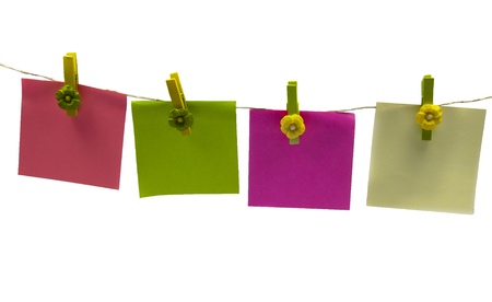clothespins with papers in green pink yellowの写真素材