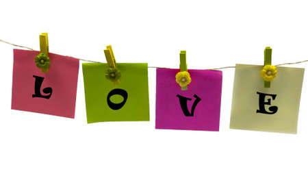 clothespins with papers in green pink yellowの写真素材