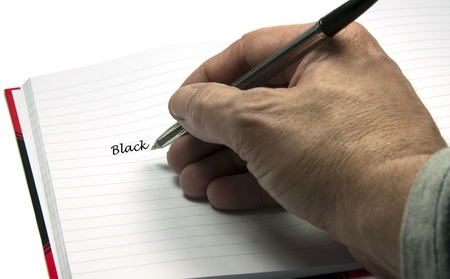 hand with pen writing blackの写真素材