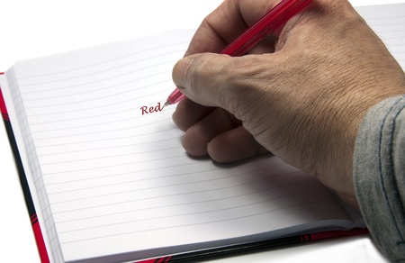 hadn with a pen writing redの写真素材