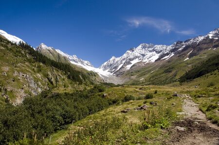 snow on the mountains in summer in Switzerland on the Flazeralpsの写真素材