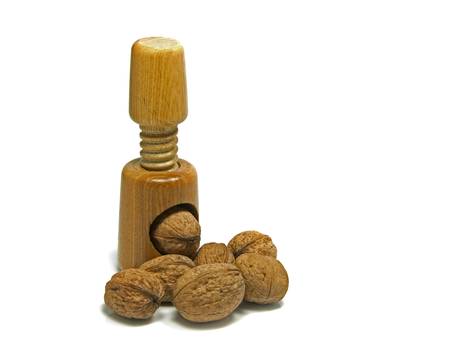wooden nutcracker isoalted on white with walnutsの写真素材