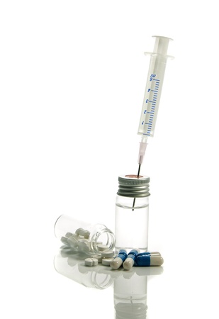 medical needle in bottle with liquid isolated on whiteの写真素材