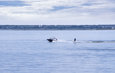 people in the boat and water ski behind it on the haringvliet in Hollandの写真素材