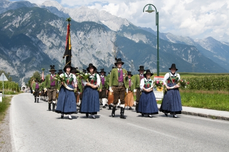 AXAMS,AUSTRIA - AUGUST 15 Unidentified people walking in procession to the church on Maria Ascension,on August 15, 2012 in Axams, Austria  Maria Ascension is the anual christian celebration in Axamのeditorial素材