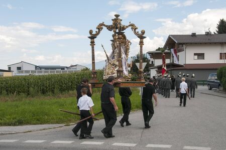 AXAMS,AUSTRIA - AUGUST 15 Unidentified people walking in procession to the church on Maria Ascension,on August 15, 2012 in Axams, Austria  Maria Ascension is the anual christian celebration in Axamのeditorial素材