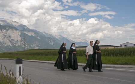 AXAMS,AUSTRIA - AUGUST 15 Unidentified people walking in procession to the church on Maria Ascension,on August 15, 2012 in Axams, Austria  Maria Ascension is the anual christian celebration in Axamのeditorial素材