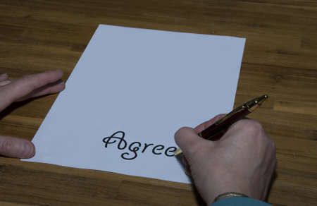 female giving agree by writing contractの写真素材