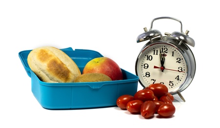 twelve o clock lunchtime with bread and fruitの写真素材