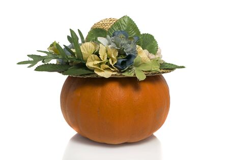 One big orange pumpkin with summer hat  over white backgroundの写真素材