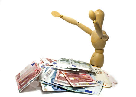 wooden puppet in euro moneyの写真素材