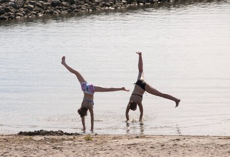 HELLEVOETSLUIS,HOLLAND - JULY 22:Unidentified girls practice gymnastics on the beach near the sea on July 22 2012 in Hellevoetsluis,Netherlands. The first sunn y day of summer in Holland

のeditorial素材
