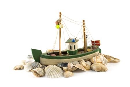 old danish model fish boatand beach shell isolated on whiteの写真素材