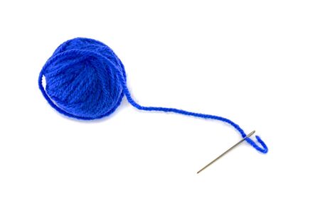 ball of blue wool and metal needleの写真素材