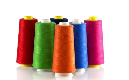 orange red blue green and pink bobbin isoalted on whiteの写真素材