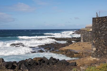 the coast with sea and waves at the west side of Tenerife Islandの写真素材