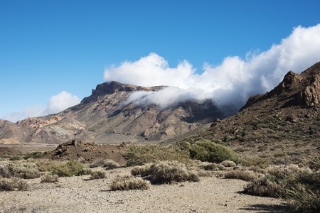 clouds over the mountains in nature parc de Teide on Tenerifeの写真素材