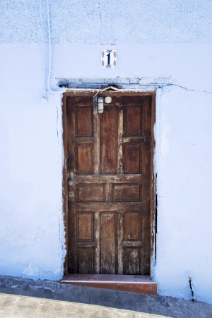 old wooden door with blue painted wallのeditorial素材
