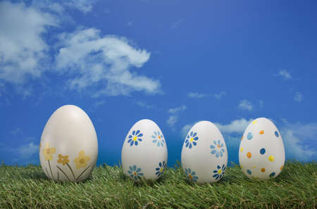 easter eggs in green grass with blue skyの写真素材