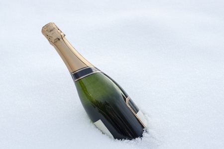 full bottle champagne in the winter snowの写真素材