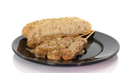 asian dish with bread and sate on white backgroundの写真素材