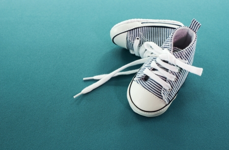 small baby sport shoes on blue backgroundの写真素材