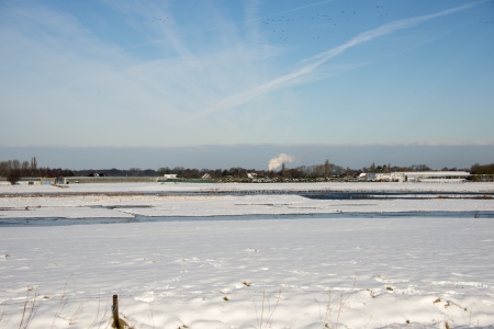 snow in winter landscape with birds and waterの写真素材