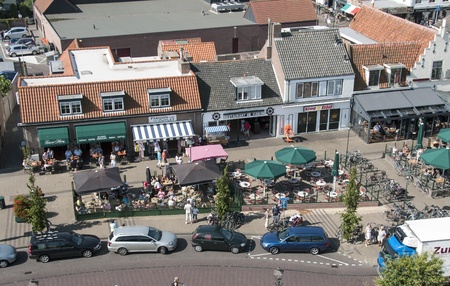 People having fun on  a terrace in Renesse , Holland, the first day this summer with sun and good temperatureのeditorial素材