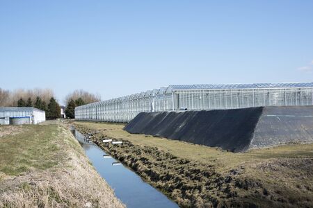outside greenhouse with water bassin for irrigationの写真素材