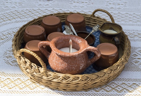 braided basket with tea set on tbale with crochet rugの写真素材