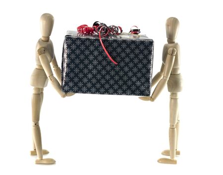 two wooden man holding a black present with red decorationの写真素材