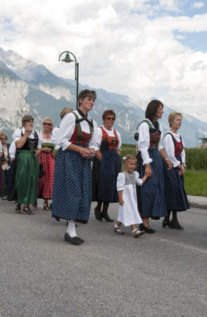 AXAMS,AUSTRIA - AUGUST 15 Unidentified peoplewalking in procession to the church on Maria Ascension,on August 15, 2012 in Axams, Austria  Maria Ascension is the annual christian celebration in Axamのeditorial素材