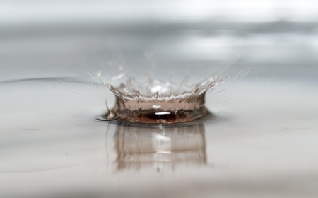 movement of a falling water drop red wine in fresh waterの写真素材