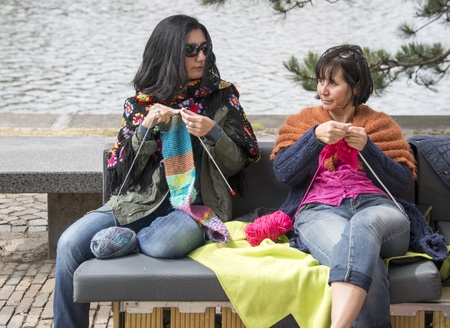 HELLEVOETSLUIS,HOLLAND - JUNE 29 Unidentified woman knitting on a sofa outside,on June 29,2013 in Hellevoetsluis,Holland This days is once a year to introduce art and cultureのeditorial素材