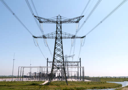 Electricity pylon with pwer lines and blue skyの写真素材