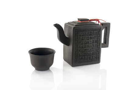 asian teapot and cup isolated on whiteの写真素材