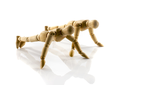 couple wooden puppets workout isolated on whiteの写真素材