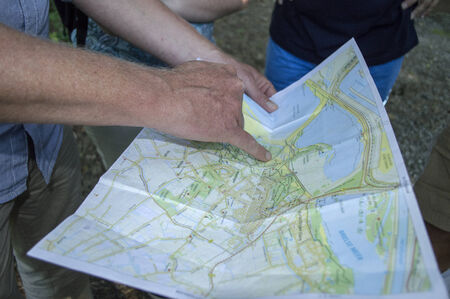 people pointing on the map for the destination