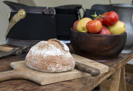 fresh bread and red tomatoes with soldiers caps on the backgrondの写真素材