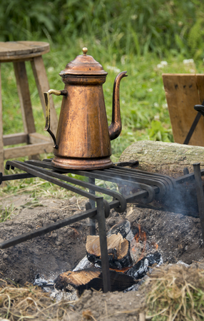 copper teapot on campfireの写真素材