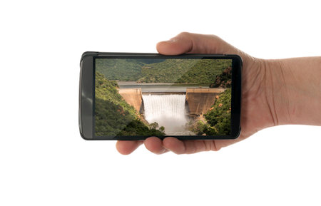 female hand with mobile phone isolated on white withswadine waterfall south africaの写真素材