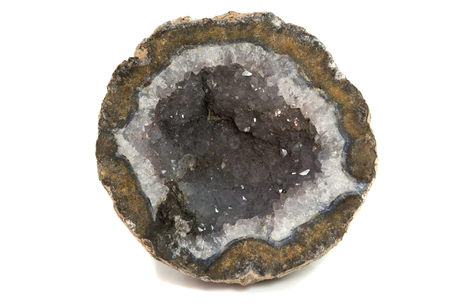 crystals in gem stone geode isolated on whiteの写真素材