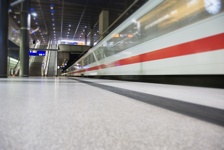 high speed white train crossing trainstation in Berlin Germanyのeditorial素材