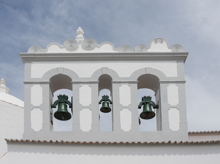 three copper bells in clock tower from catholic church in louleの写真素材