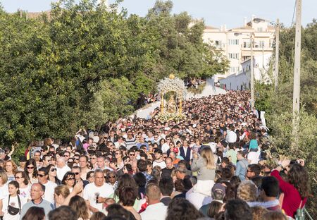 LOULE,PORTUGAL-APRIL19, 2015: man are bringing the 600 kg heavy statue of the Holy Maria to the church in Loule on April 19 2015,This proccesion called Festa da Mae Soberana is 14 days after easterのeditorial素材