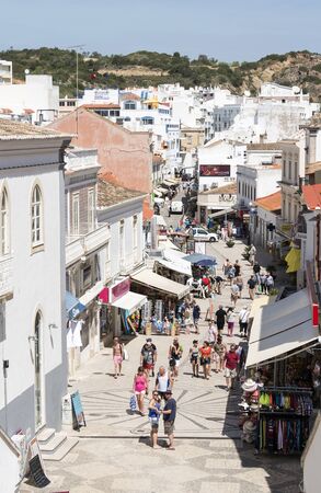 people shopping in the main street albufeira in portugal during vacationのeditorial素材