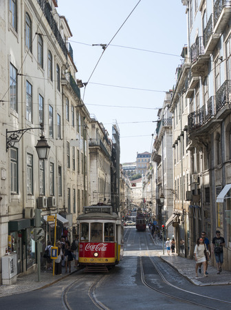LISBON, PORTUGAL - SEPTEMBER 26: Unidentified people getting on the Yellow tram  goes by the street of Lisbon city center on September 26, 2015. Lisbon is a capital and must famous city of Portugalのeditorial素材