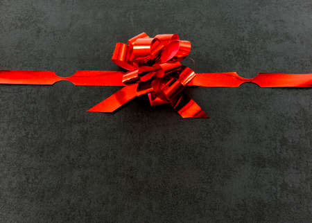 red gift ribbon bow isolated on black